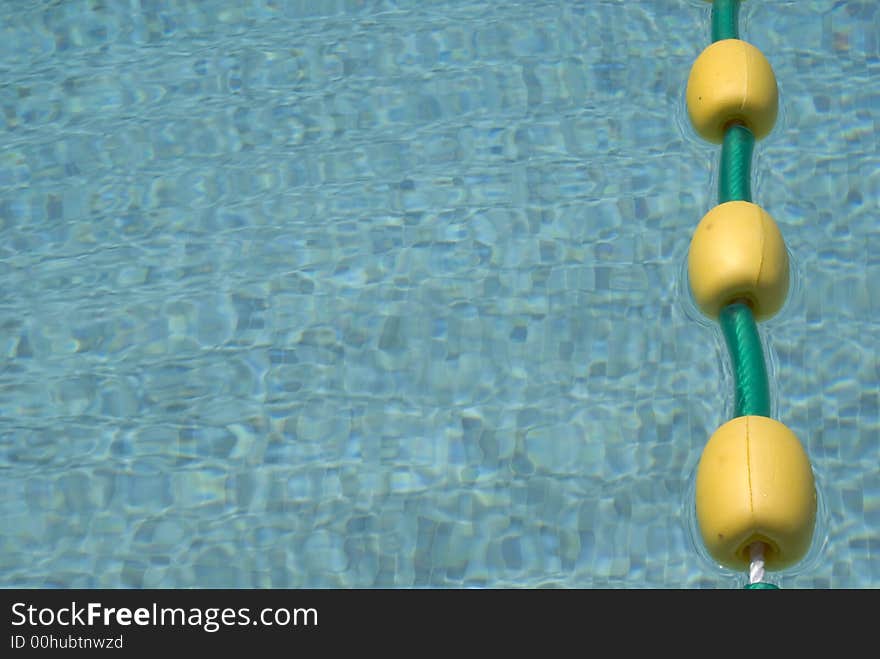 Close up of a pool with a line of yellow floats. Close up of a pool with a line of yellow floats