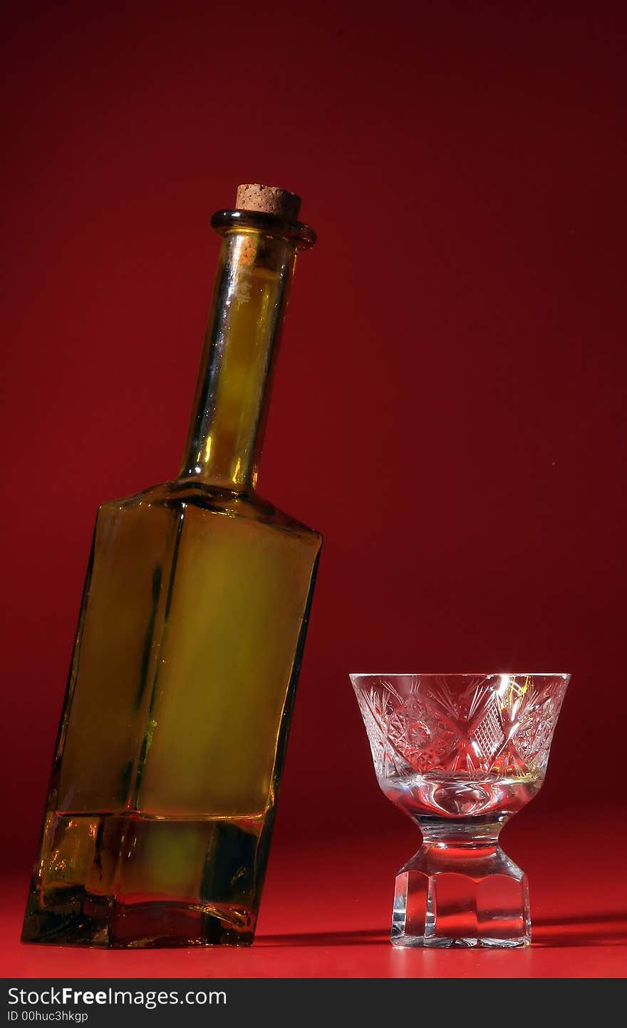 Bottle of brandy on red background. Bottle of brandy on red background