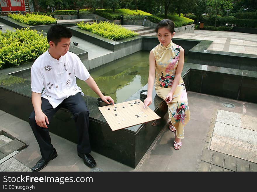 Asian young people play chess. Asian young people play chess