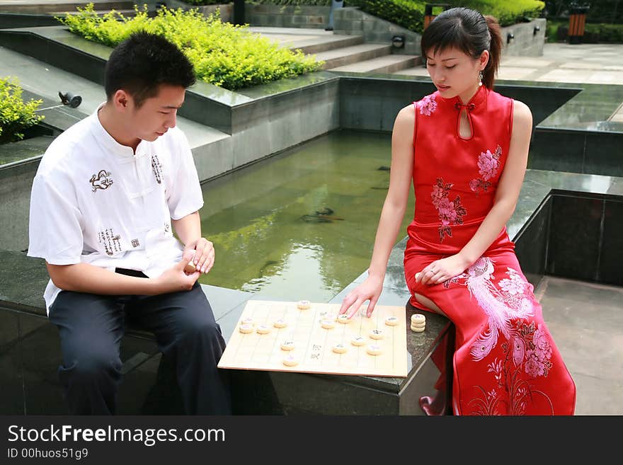 Asian young people play chess. Asian young people play chess