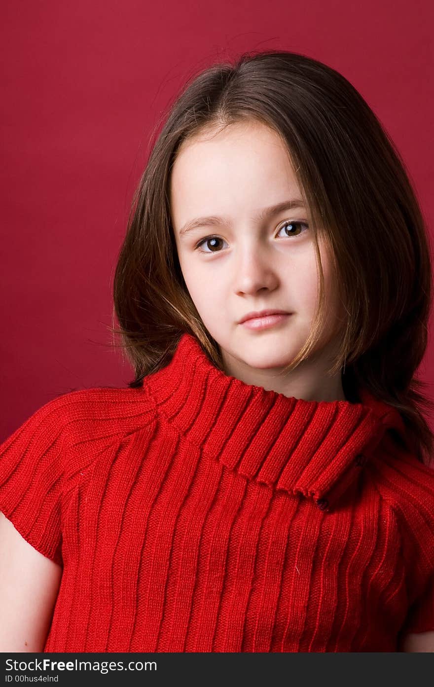 The girl of ten years in a red sweater in studio. The girl of ten years in a red sweater in studio