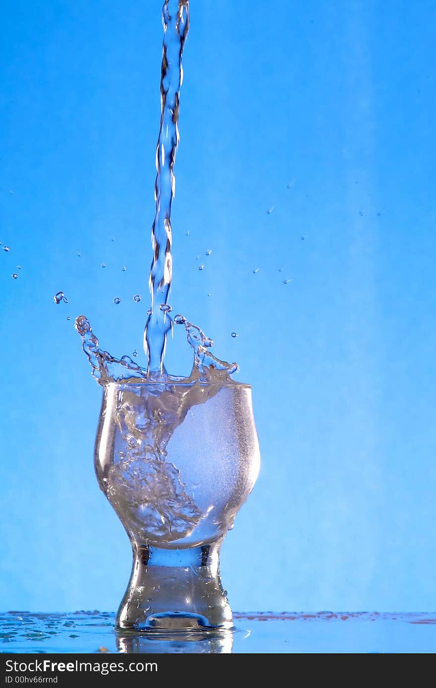 A glass with a drink splashing about. A glass with a drink splashing about