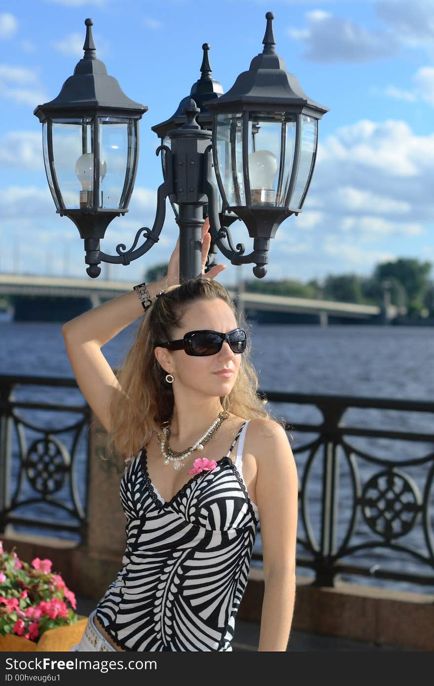 Beautiful young girl with sunglasses in the city. Beautiful young girl with sunglasses in the city