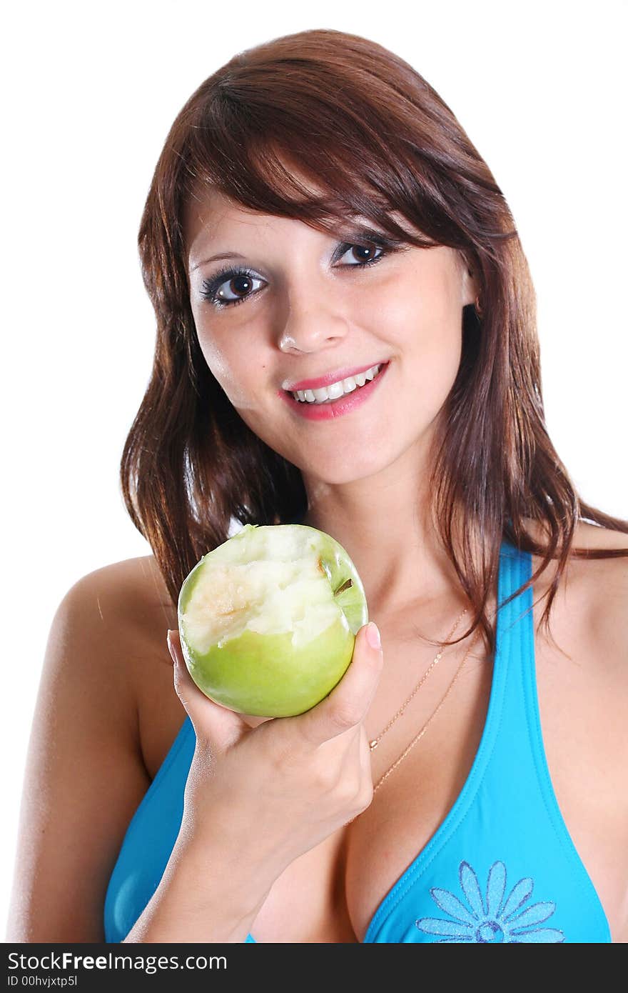 The beautiful sexual girl in bikini eats an apple. The beautiful sexual girl in bikini eats an apple