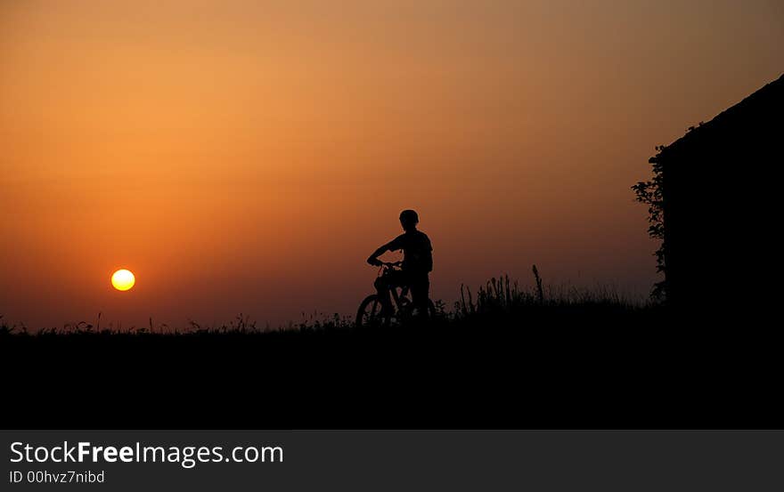 Mountain biker silhouette in sunrise