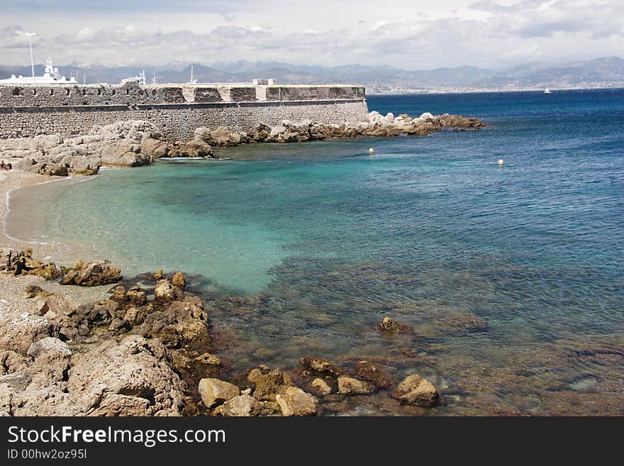 Antibe beach, France with port wall in distance