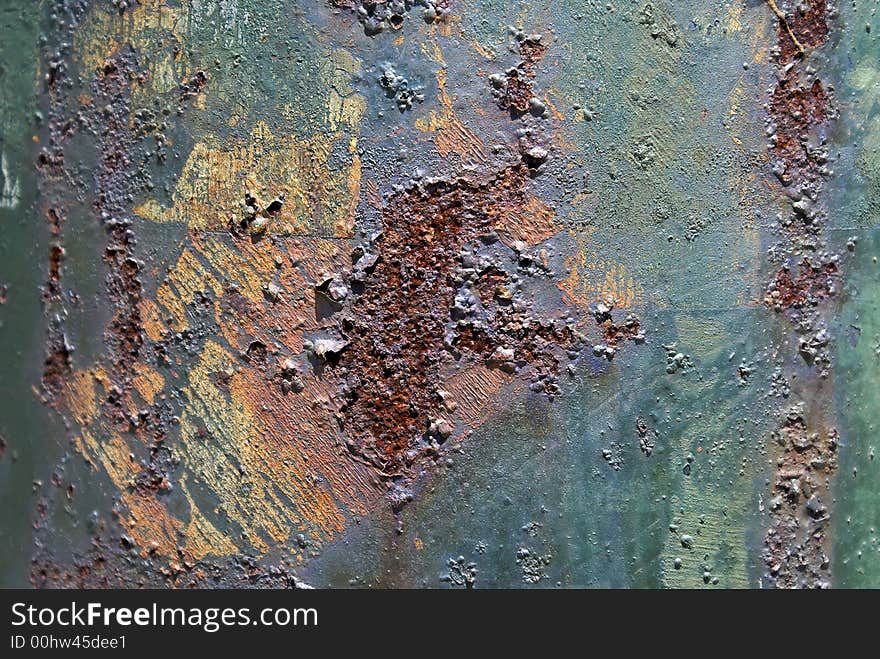 Close up of rusted utility pole, pock marked and blistered
