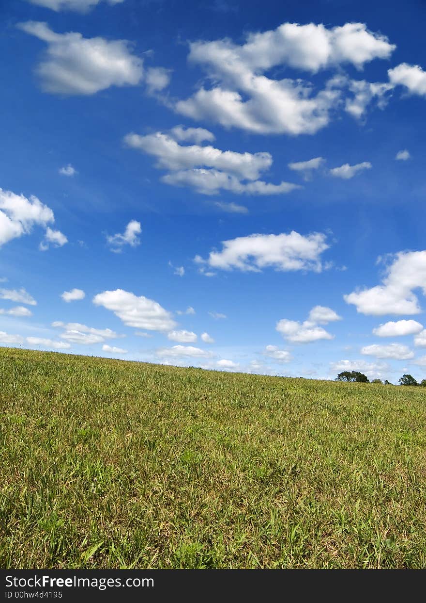 Cloudy sky over a grassy hill. Cloudy sky over a grassy hill