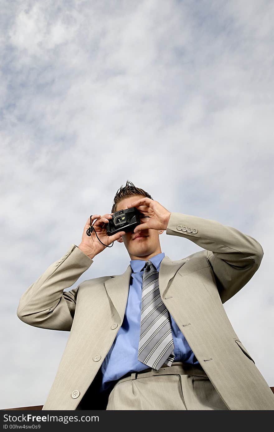 Young businessman with camera