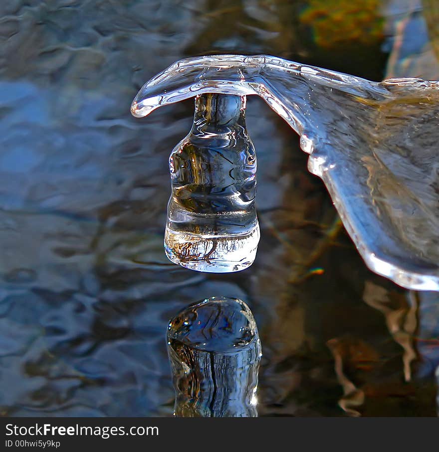 A close up of the aglint icicle of a unusual form above water. Russian Far East, Primorye. A close up of the aglint icicle of a unusual form above water. Russian Far East, Primorye.