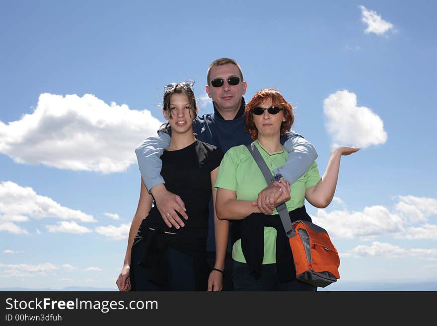 Loving familz together, mom is holding a heart shaped cloud in her hand. Loving familz together, mom is holding a heart shaped cloud in her hand