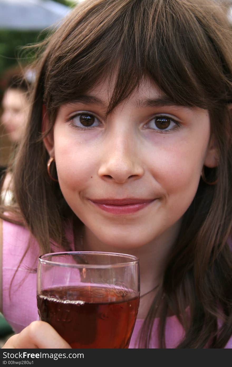 Beautiful young girl preparing to drink a cooling glass of juice. Beautiful young girl preparing to drink a cooling glass of juice