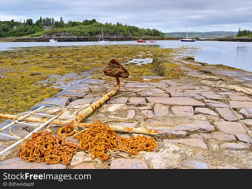 Rusty anchor on jetty