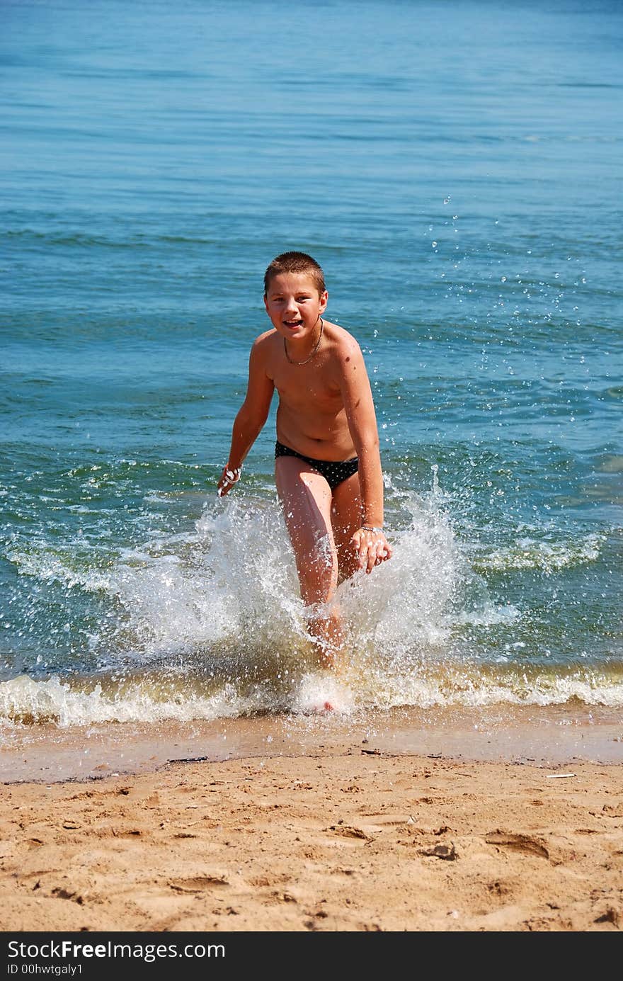 A boy walking in water. A boy walking in water