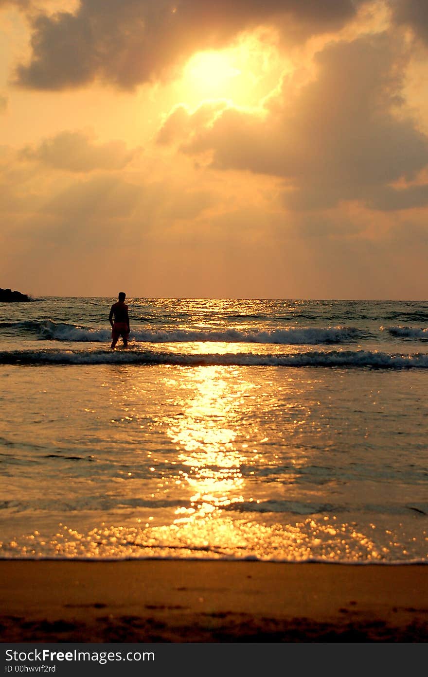 A man walking along a golden sunset