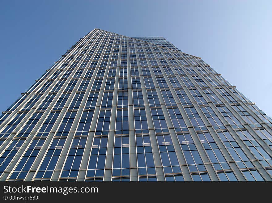 A modern glass office tower rising into the sky. A modern glass office tower rising into the sky