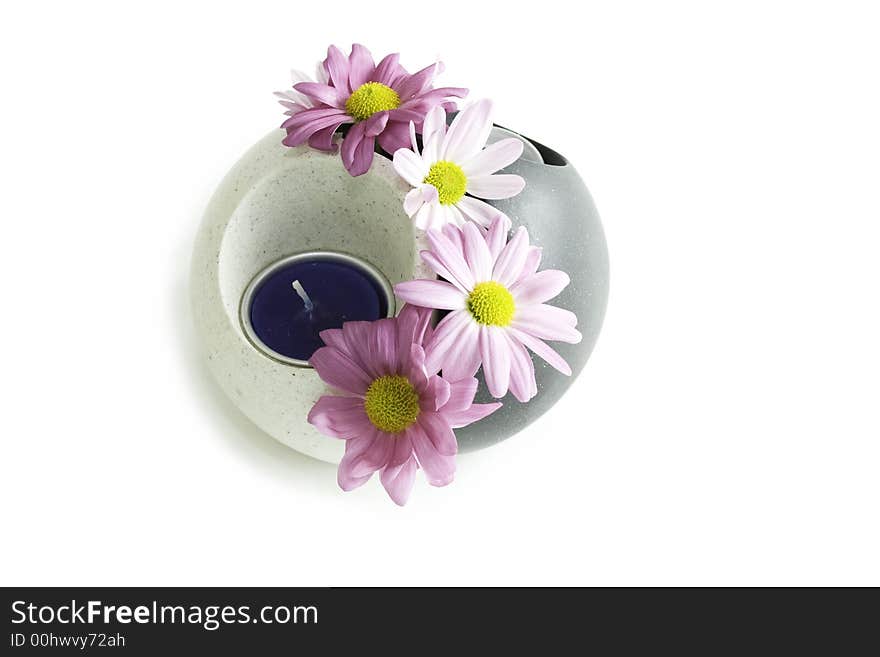 A yin yang candle holder with pink chrysanthemum. A yin yang candle holder with pink chrysanthemum