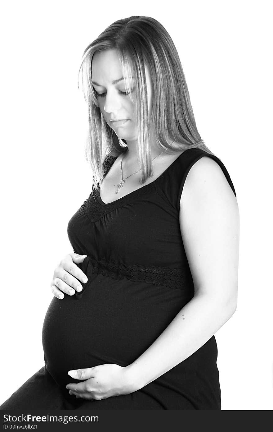 A very beautiful pregnant woman holding her tummy. A very beautiful pregnant woman holding her tummy.