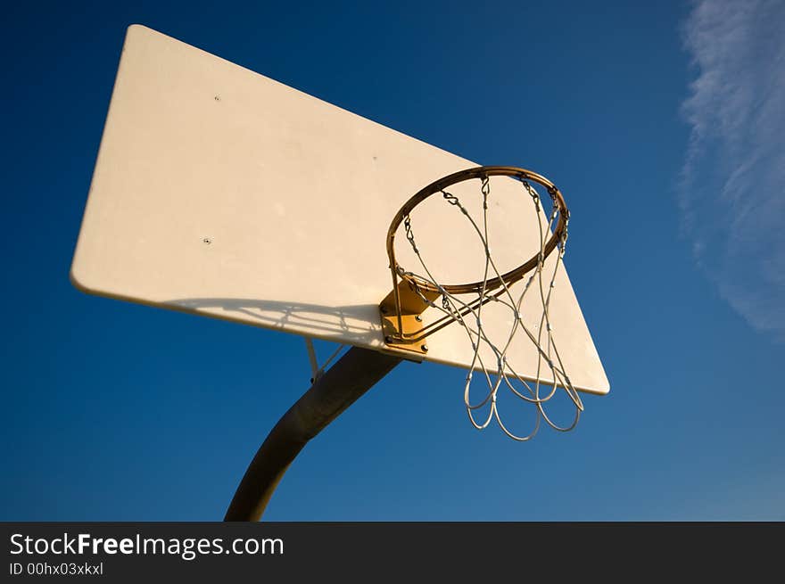 Basketball hoop and net with blue sky background. Basketball hoop and net with blue sky background