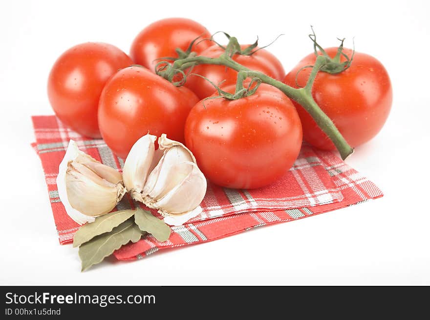 Tomatoes, garlic, bay leaf on white background