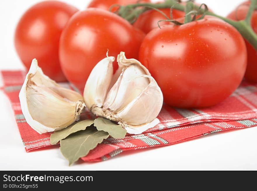 Tomato, garlic, bay leaf on white background