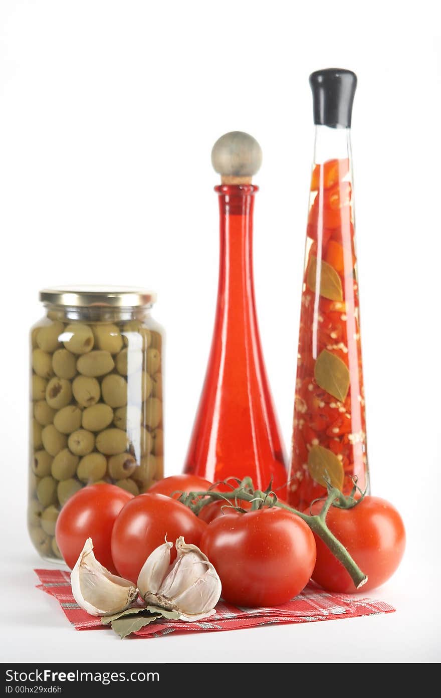 Tomatoes, garlic, bay leaf on white background