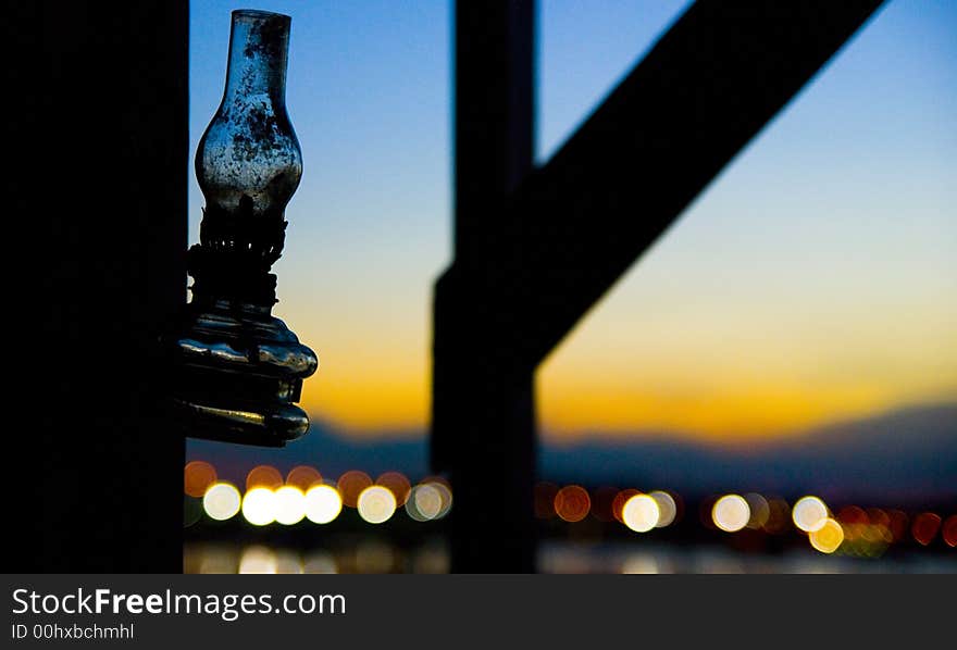 A solitude kerosene lamp hangs silently as the day changes from evening to dusk. A solitude kerosene lamp hangs silently as the day changes from evening to dusk