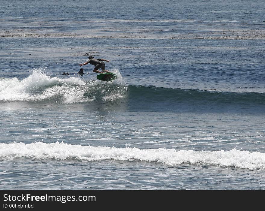 Surfer doing a 180 air. Surfer doing a 180 air