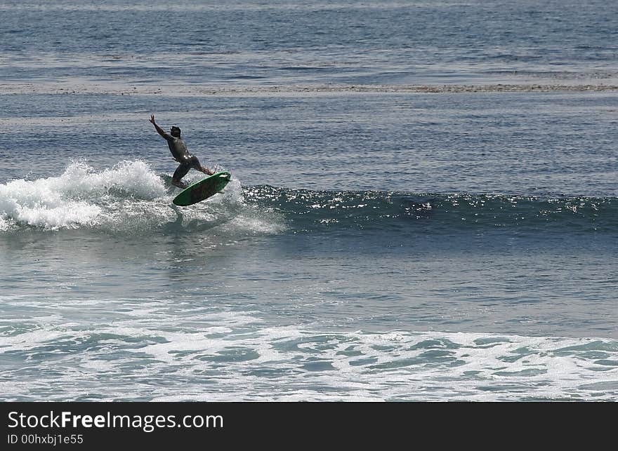 Surfer doing a 180 air. Surfer doing a 180 air