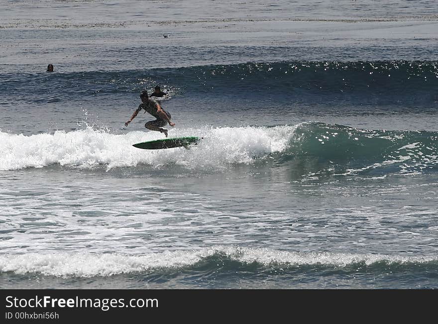 Surfer doing a 180 air. Surfer doing a 180 air