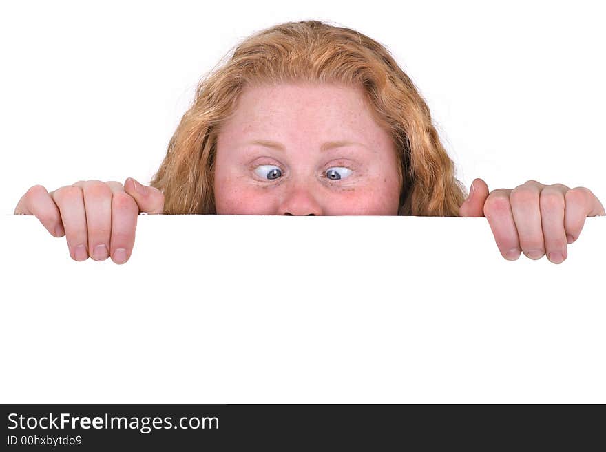 Cute curly girl looking at something very intensely with eyes crossing. Isolated behind a white board, with lots of copyspace. Cute curly girl looking at something very intensely with eyes crossing. Isolated behind a white board, with lots of copyspace