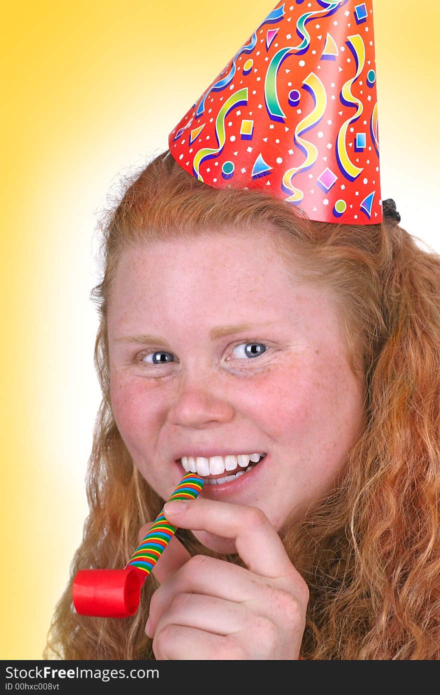 Birthday girl portrait with a party hat and wide smile over yellow background. Birthday girl portrait with a party hat and wide smile over yellow background