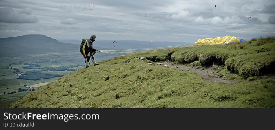 A view from the top of Whernside across the  valley to Ingleborough whilst a paragliding competition existed in the Yorkshire Dales, England. A view from the top of Whernside across the  valley to Ingleborough whilst a paragliding competition existed in the Yorkshire Dales, England.