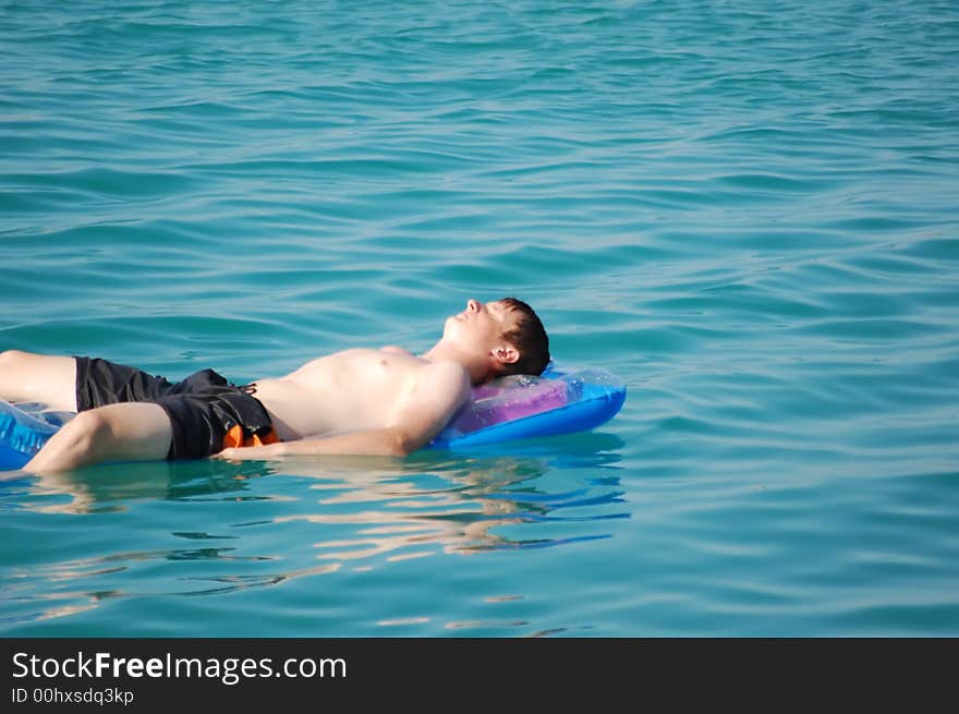 Boy is relaxing at the pool. Boy is relaxing at the pool