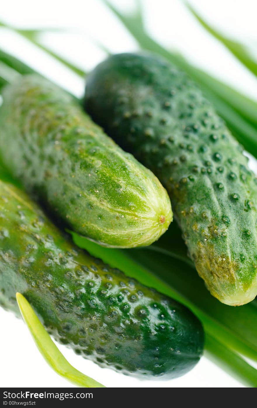 Green fresh cucumbers on white