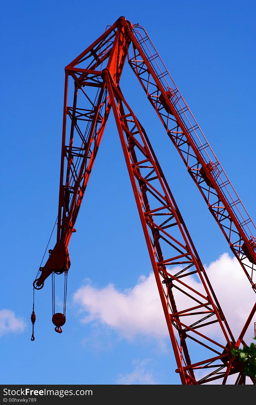 A photo of a red old crane in a dock. A photo of a red old crane in a dock