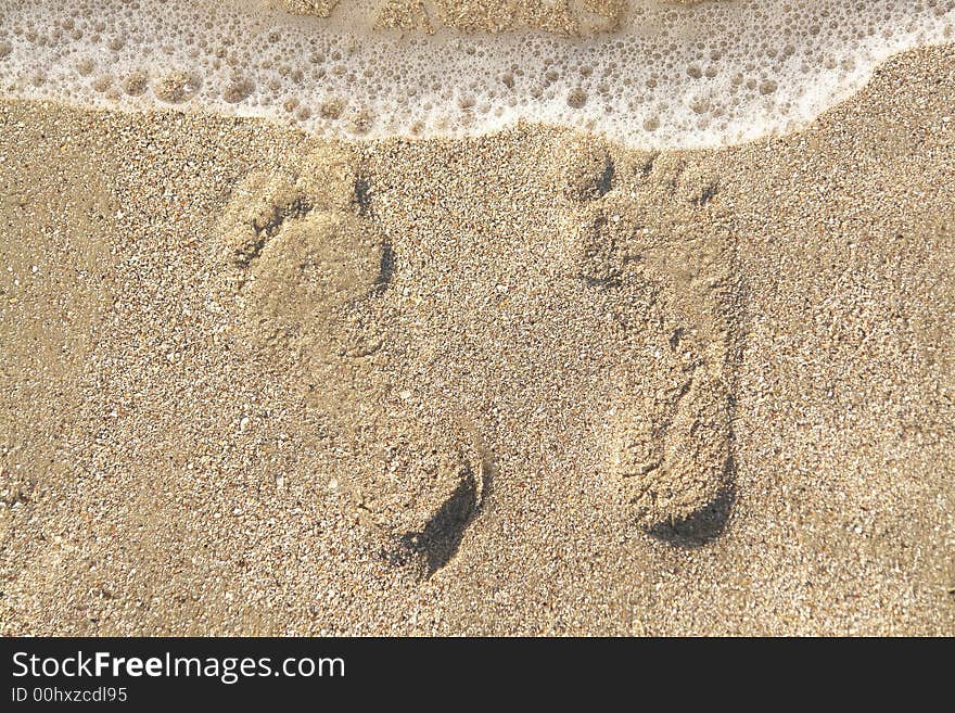 Two men's footprints on the sand. Two men's footprints on the sand