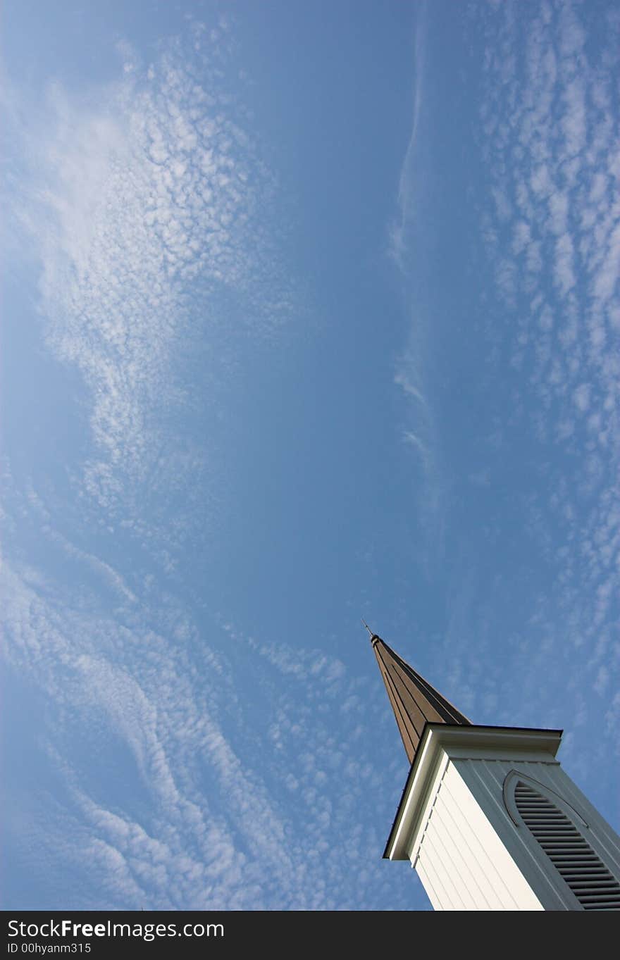 Church steep with blue sky and cirrus clouds, ample room for text. Church steep with blue sky and cirrus clouds, ample room for text