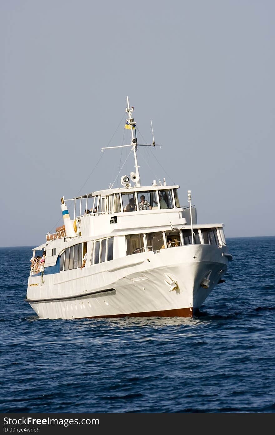 The white passenger steam-ship floating on the blue sea. The white passenger steam-ship floating on the blue sea