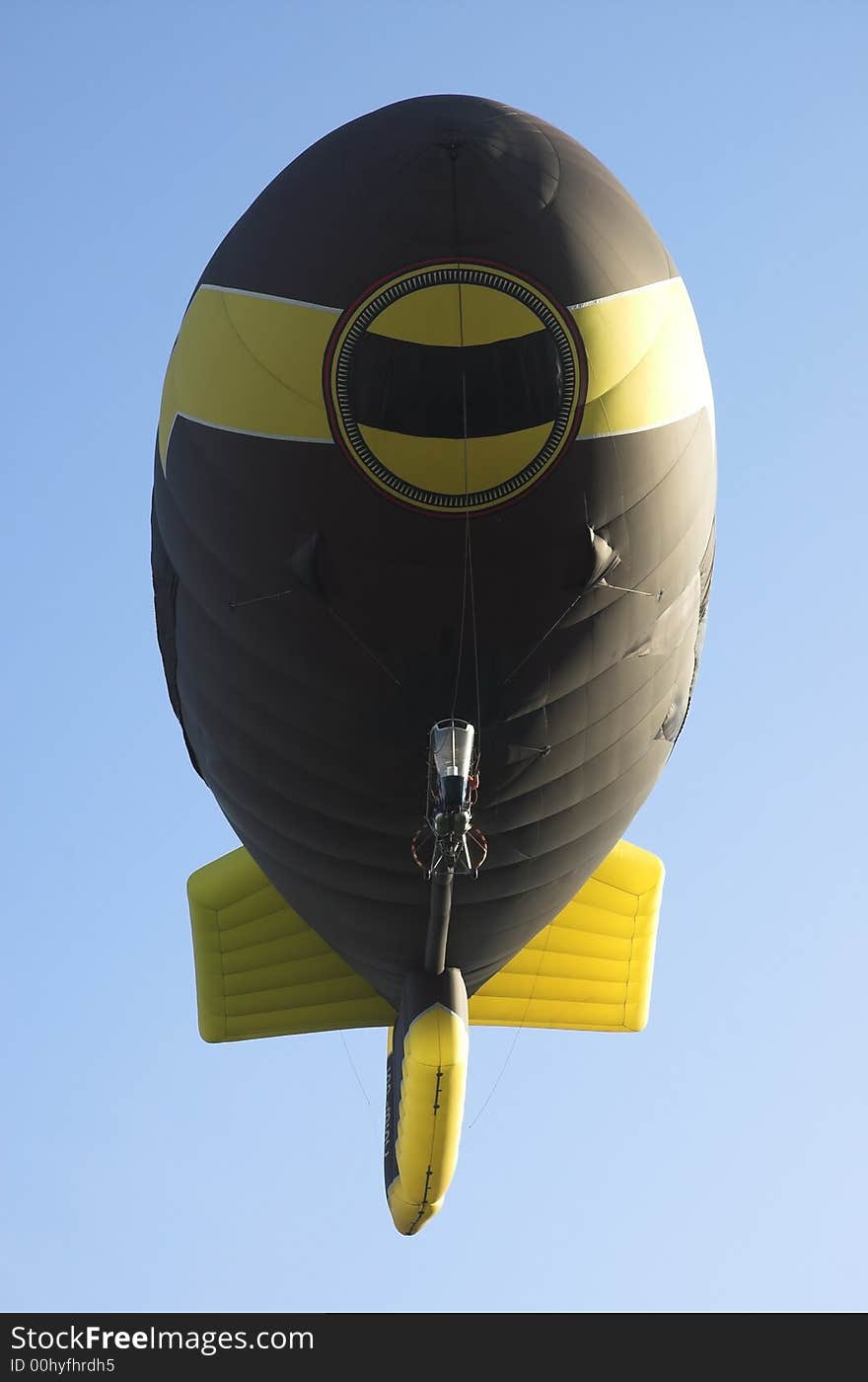 Dirigible balloon in the dark blue sky