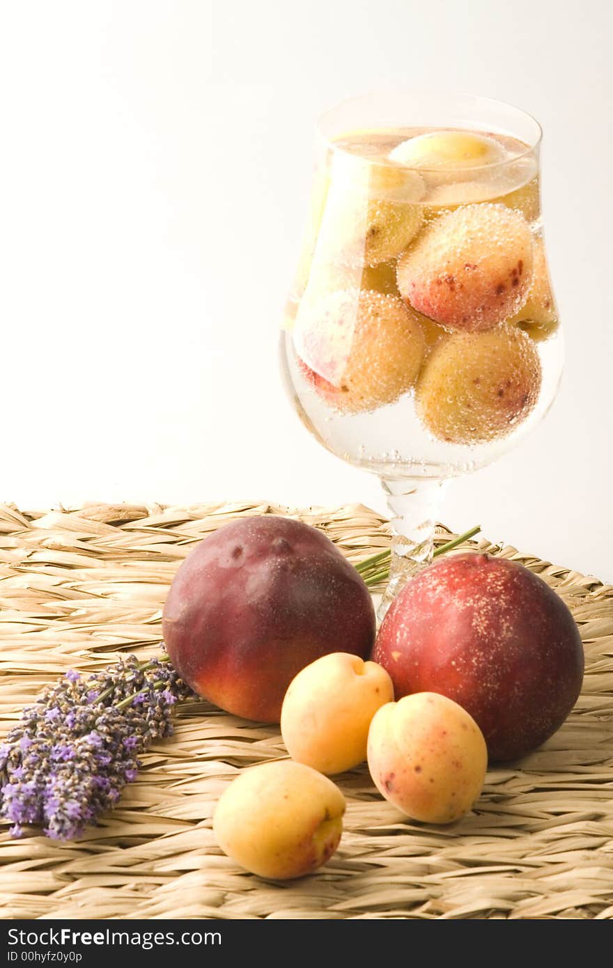 Peaches and apricots with lavender are on the table. Peaches and apricots with lavender are on the table