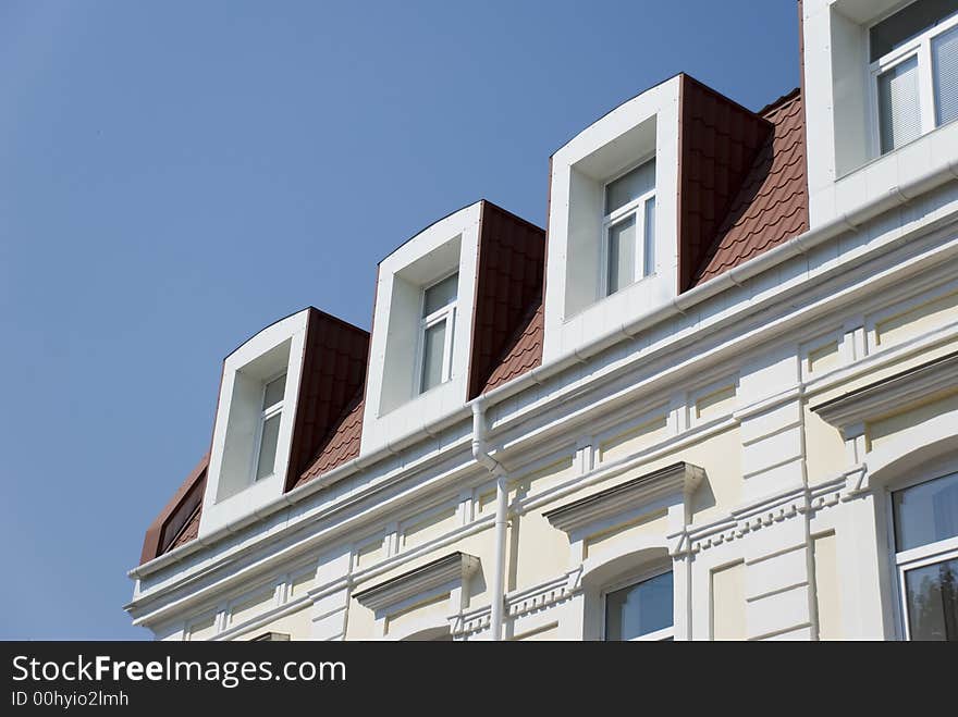 Facade of a building with attics. The ancient restored building