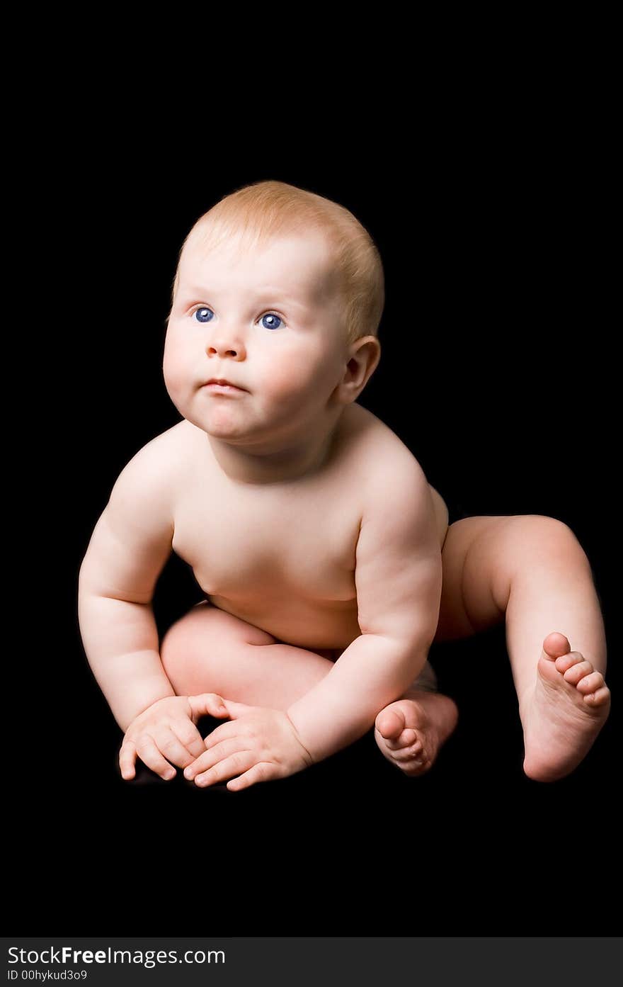 The small child in studio, on a black background. The small child in studio, on a black background