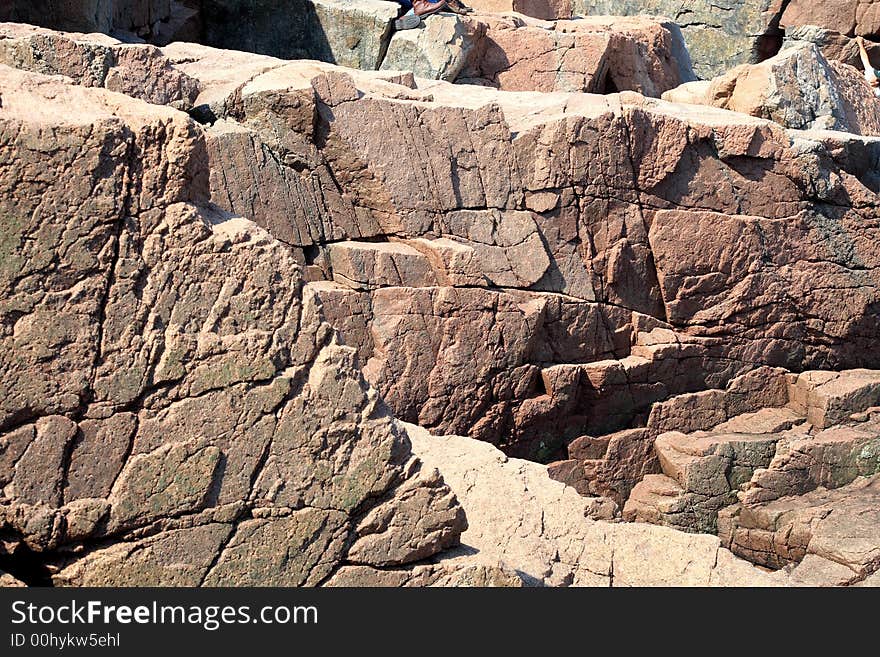 A pink granite wall in Acadia National Park. A pink granite wall in Acadia National Park