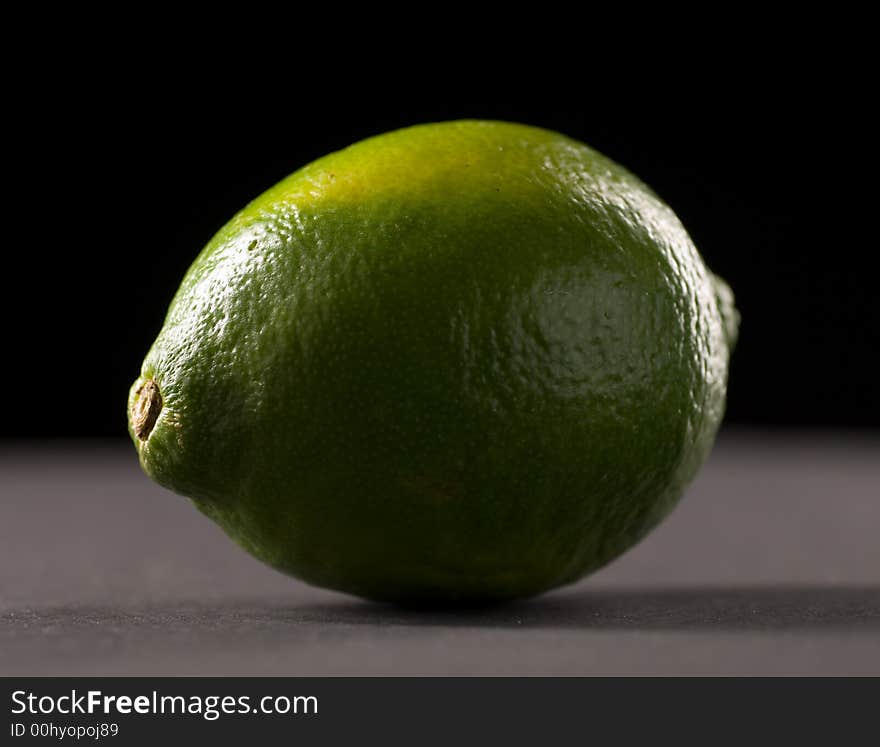 Single lime with a black background