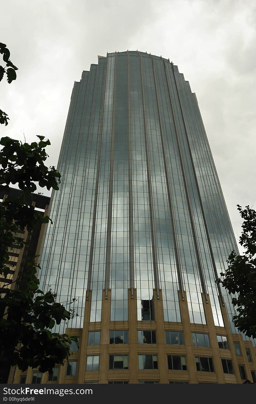 Back Bay reflective glass skyscraper surrounded by trees. Back Bay reflective glass skyscraper surrounded by trees