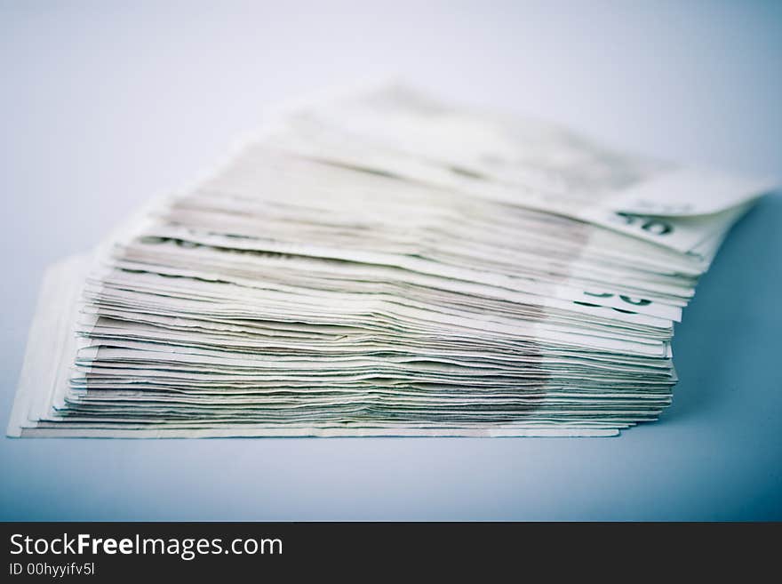 Pile of fifty euro banknotes on blue background. Pile of fifty euro banknotes on blue background.