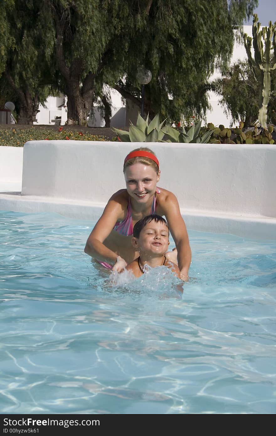 Happy Boy And Mom In Pool