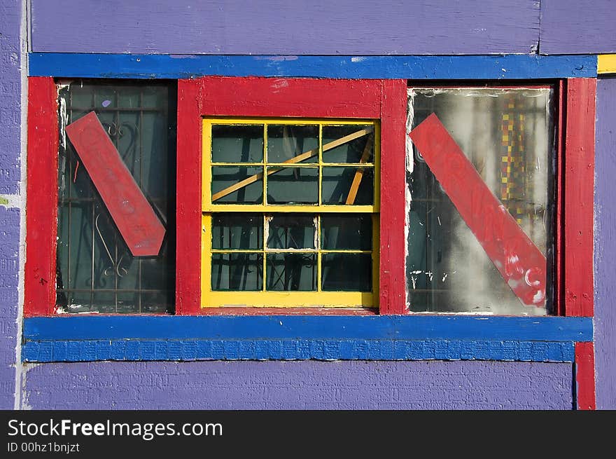 A brightly colored window of an abandoned urban day care center. A brightly colored window of an abandoned urban day care center