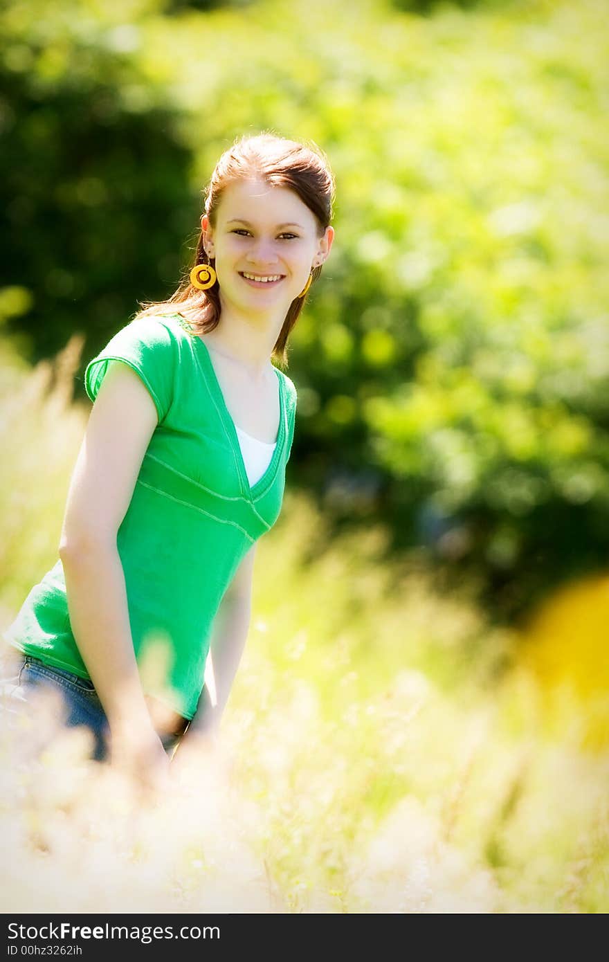 Portrait of a beautiful teen in a sun-drenched field. Portrait of a beautiful teen in a sun-drenched field.